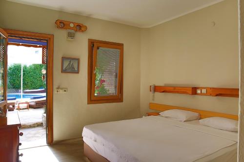 A bed or beds in a room at UzHan Beach Hotel