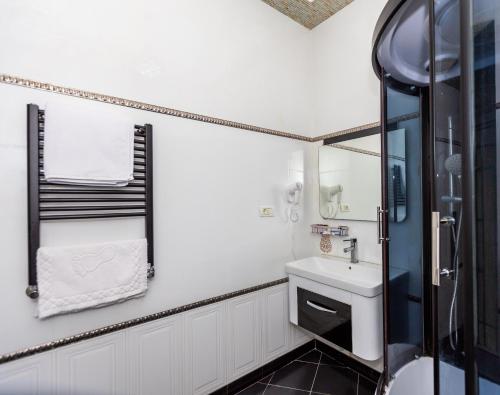 a bathroom with a sink and a shower at Lacasa Nizami Street Hotel in Baku