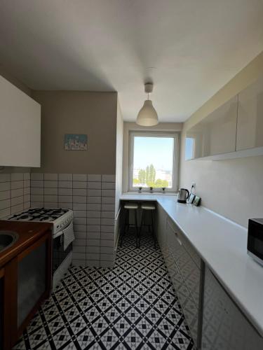 a kitchen with a sink and a stove top oven at Do Gdyni in Gdynia