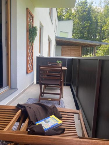 a patio with a table and a chair on a balcony at Apartma Pohorje in Hočko Pohorje