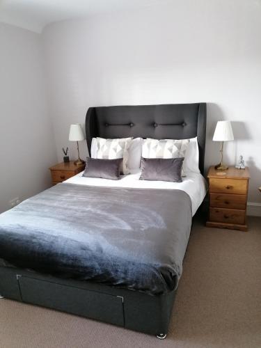 a bedroom with a large bed with two night stands at 5 in Preston