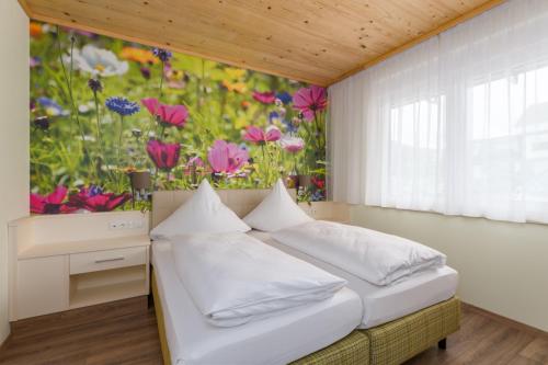 a bedroom with a flower painting on the wall at Mosel Village Resort in Ellenz-Poltersdorf