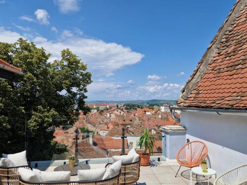 a balcony with chairs and a view of a city at MAGISTER seven in Sibiu