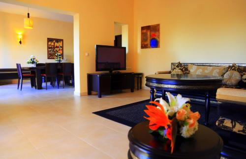 a living room with a couch and a tv at Labranda Targa Aqua Parc in Marrakech