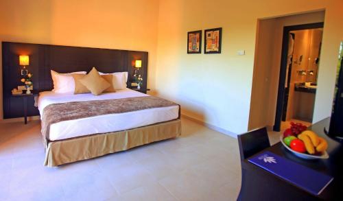 a bedroom with a bed and a bowl of fruit on a table at Labranda Targa Aqua Parc in Marrakech