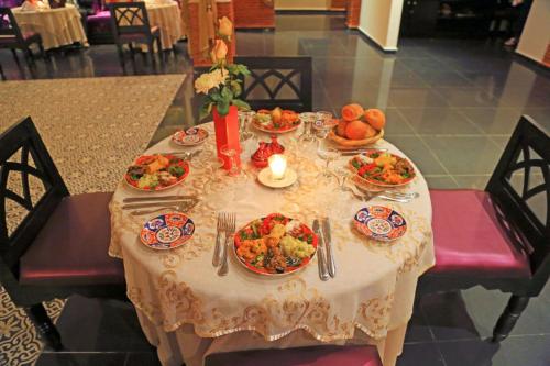 a table with plates of food on it at Labranda Targa Aqua Parc in Marrakech