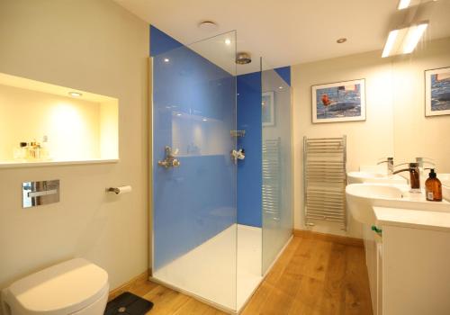 a bathroom with a shower and a toilet and a sink at Kingswood in Edinburgh