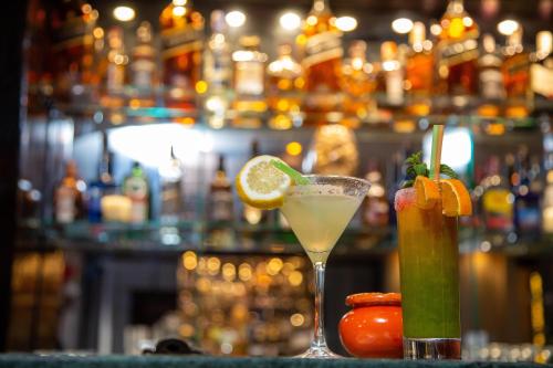 a drink on a bar with a lime and a cocktail at Rose Aqua Park Hotel in Marrakesh