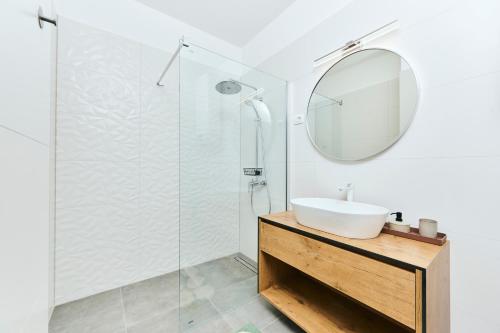 a bathroom with a sink and a mirror at Apartments San Maris 2 in Umag