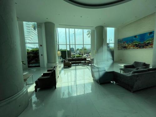 a lobby with couches and chairs in a building at Atlantis condo G bless in Jomtien Beach