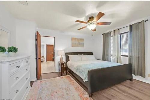 a bedroom with a bed and a ceiling fan at Beautiful Oasis with rv or boat parking in Las Vegas