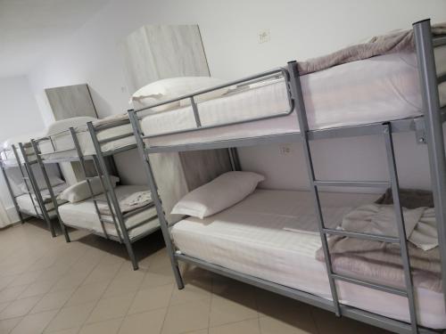 a group of bunk beds in a room at Hostel K13 in Sarandë