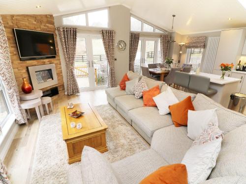 a living room with a couch and a table at 8 Waterside Wood in Windermere