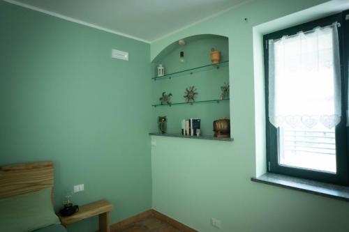 a room with a window and shelves on the wall at Il Bosco Incantato in Borgo San Dalmazzo