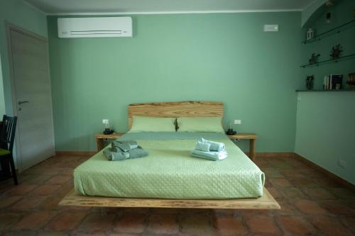 a bedroom with a bed with two towels on it at Il Bosco Incantato in Borgo San Dalmazzo