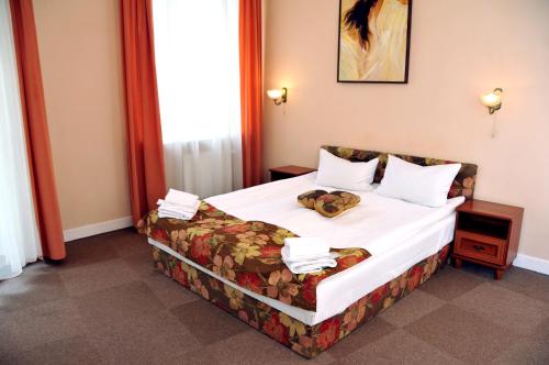 a hotel room with a bed in a room at Hotel Irena in Lviv