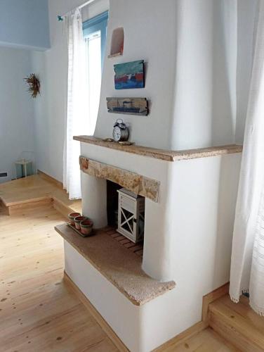 a living room with a fireplace in the wall at Blue & White Cycladic house - 100m from the beach in Megas Gialos - Nites