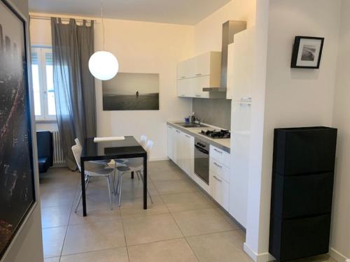 a kitchen with a table and a dining room at Residence La Nave in Senigallia