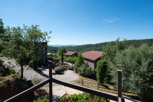 a view from the balcony of a house with a fence at Domaine de Chalvêches Hôtel SPA 4* in Faugères