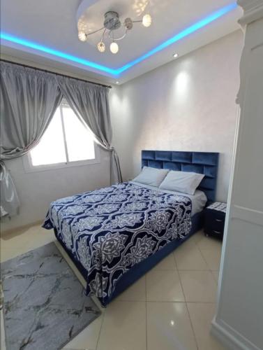 a bedroom with a bed with a blue lighting at شقة بمراكش in Marrakesh