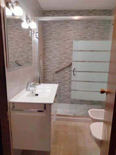 a bathroom with a sink and a toilet and a shower at Margaritas in Alcossebre