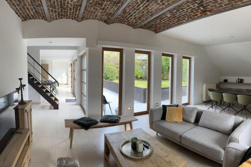 a living room with a couch and a table at House Botanique in Meise