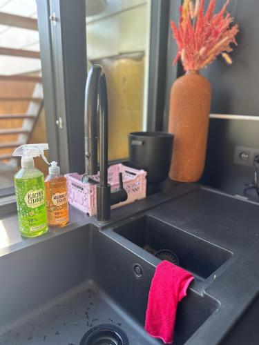 a kitchen sink with a red towel next to it at NEOZONE Neostudio Malmedy in Malmedy