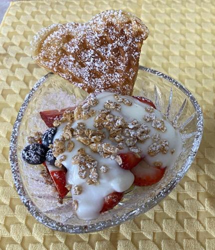 a plate of food with fruit and a piece of bread at Seabank House Bed and Breakfast Aloha in Pictou