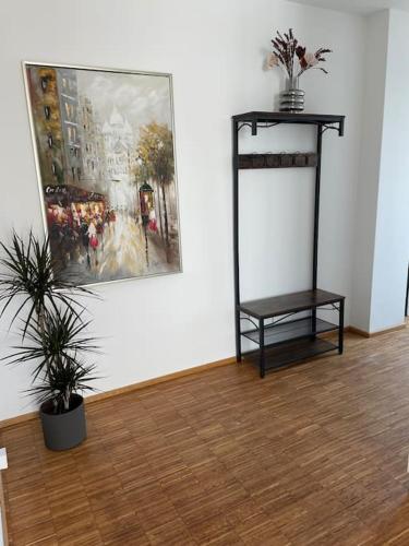 a room with a painting on the wall and a table at Penthouse-Wohnung mit Flussblick in Oldenburg