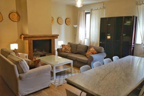 a living room with a couch and a fireplace at Castello del Calcione in Lucignano