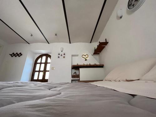 a bedroom with a large bed and a fireplace at Casa Sofia in Calascio