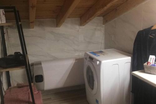 a washer and dryer in a room with a wall at 1 bedroom loft at Mytilene Port in Mytilini