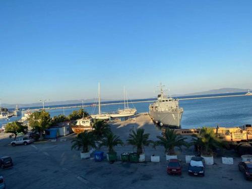 a large ship in a parking lot next to the water at 1 bedroom loft at Mytilene Port in Mytilini
