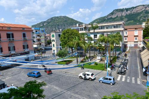 a city with cars parked in a parking lot at L'Aurora Azzurra -Luxury Suites Sorrento coast in Piano di Sorrento