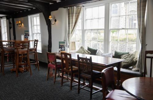 a living room with a table and chairs and a couch at Bell by Greene King Inns in Thetford