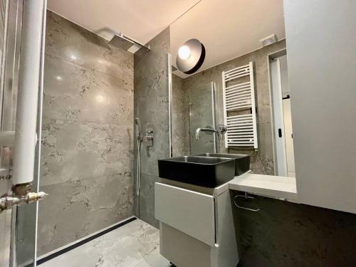 a bathroom with a sink and a shower at Bielawy Suite in Bydgoszcz