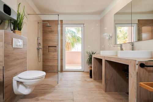 a bathroom with a toilet and a sink and a shower at Apartman Babalui in Trogir
