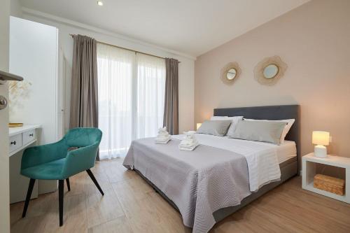 a bedroom with a large bed and a green chair at Apartman Babalui in Trogir