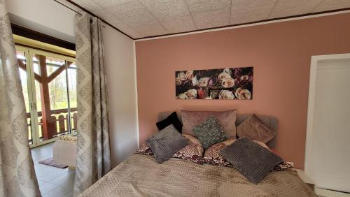a bedroom with a bed with pillows on it at Villa Blu in Sankt Kanzian