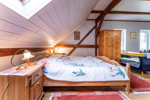 a bedroom with a large bed in a attic at Agroturystyka Ziemia Obiecana in Nielestno