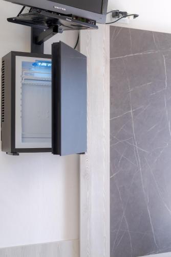 a flat screen tv hanging on a wall at Hotel Beach in Tortoreto Lido