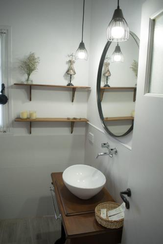 a bathroom with a white sink and a mirror at Peonias in Carhué