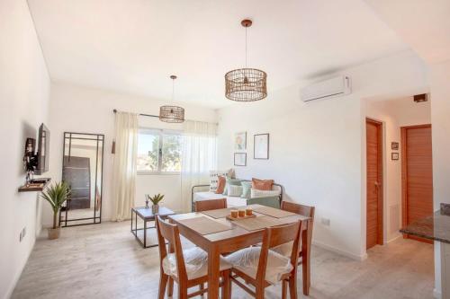 a living room with a table and a couch at ALQUILERES TEMPORARIOS MADRYN in Puerto Madryn