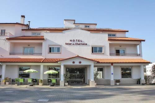 a hotel with a sign on the front of it at Hotel Solar da Charneca in Leiria
