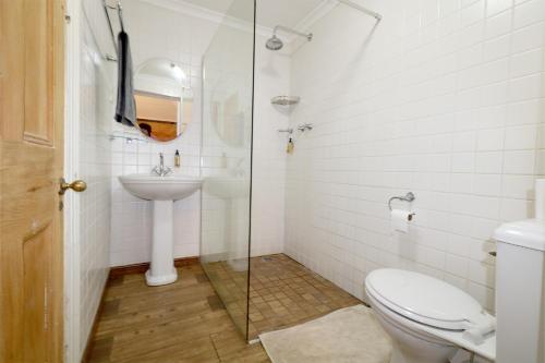 a bathroom with a toilet and a sink at THE PLACE Muizenberg in Muizenberg