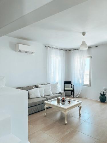 a living room with a couch and a coffee table at Aphrodite's Villa in Ambelas