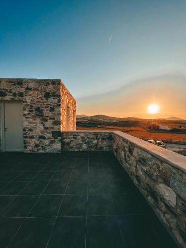 a sunset on the roof of a house at Aphrodite's Villa in Ambelas