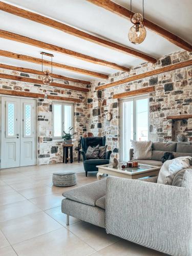 a living room with a stone wall at Aphrodite's Villa in Ambelas