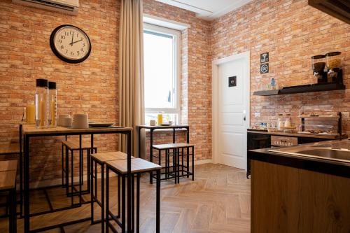 a kitchen with a clock on a brick wall at Gravina8 - Rooms in Naples in Naples