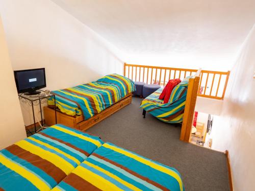 a room with two beds and a tv in it at Appartement Valfréjus, 2 pièces, 4 personnes - FR-1-468-107 in Modane